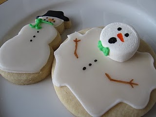 A cookie decorated as a melting snowman next to a cookie decorated as a whole snowman.