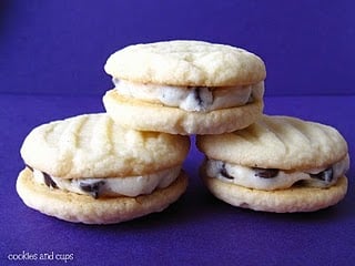 Three vanilla sandwich cookies with chocolate chip filling