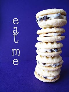 A stack of chocolate chip meltaway sandwich cookies on a blue background with the words "Eat Me".