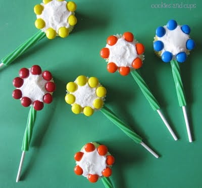 Overhead view of cupcakes decorated like flowers with stems