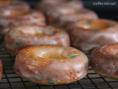 Close-up of glazed funfetti donuts on a cooling rack