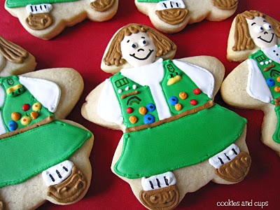 Cookies decorated like Girl Scouts.