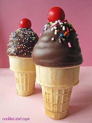Side view of two chocolate-dipped ice cream cone cupcakes