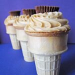 Three peanut butter brownie ice cream cones in a line