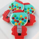 Overhead view of three gumball machine decorated cookies.