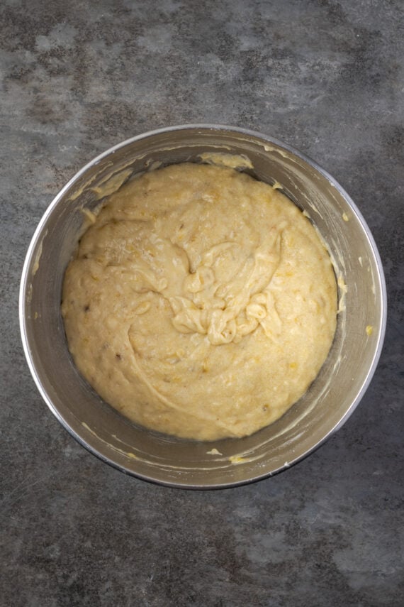 Banana cupcake batter in a metal mixing bowl.