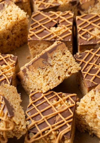 Overhead view of assorted peanut butter rice krispie treats drizzled with melted peanut butter chips.