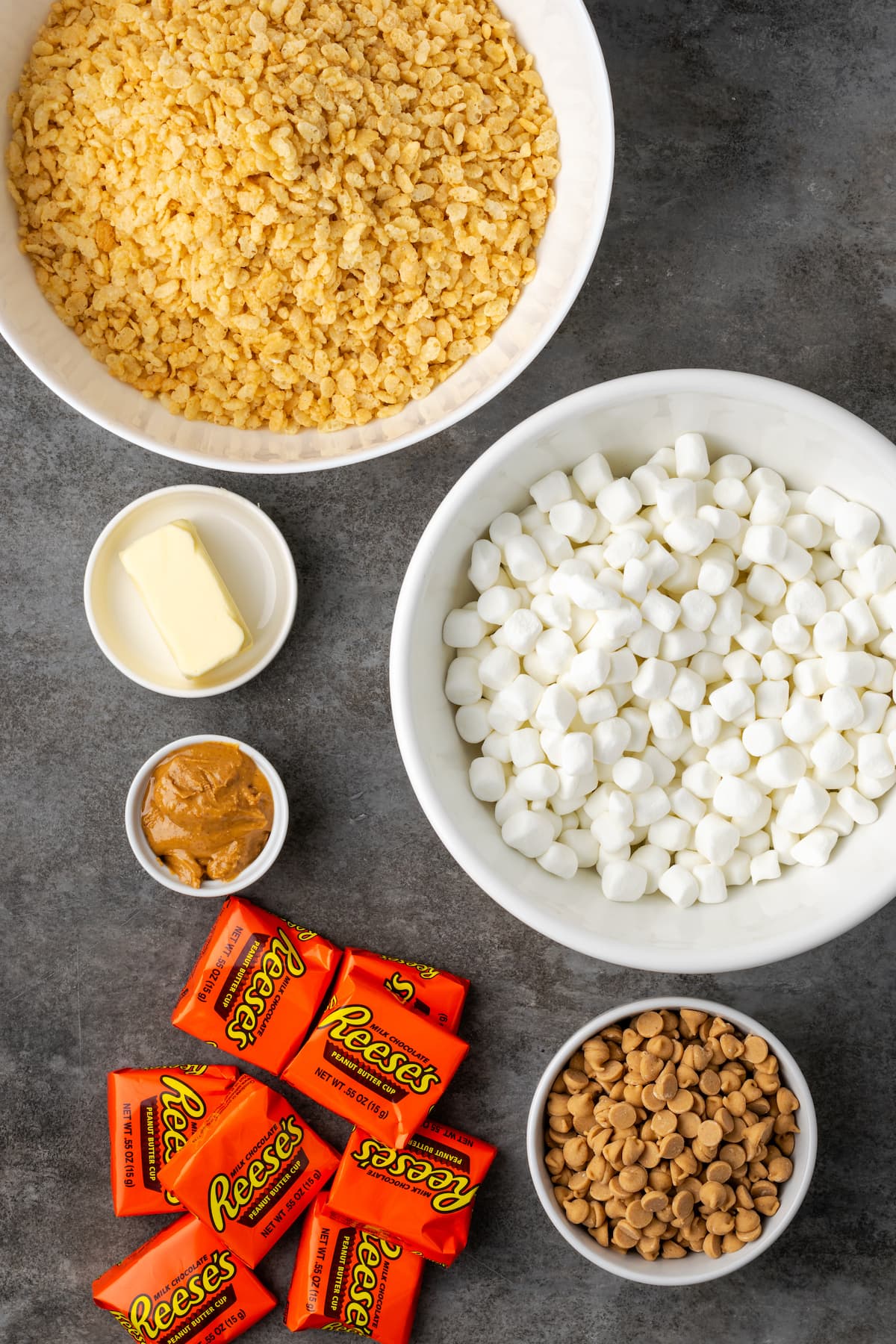 The ingredients for peanut butter rice krispie treats topped with peanut butter cups.