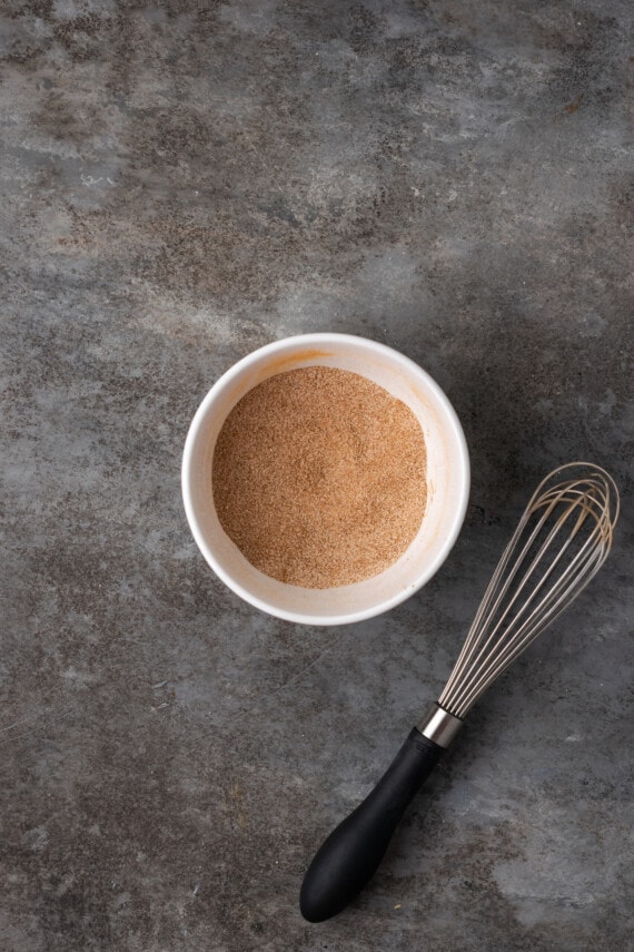 Cinnamon and sugar whisked together in a bowl.