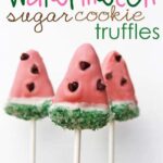 Three watermelon sugar cookie truffles on sticks.