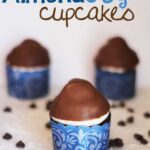 Side view of three Almond Joy Cupcakes with blue wrappers
