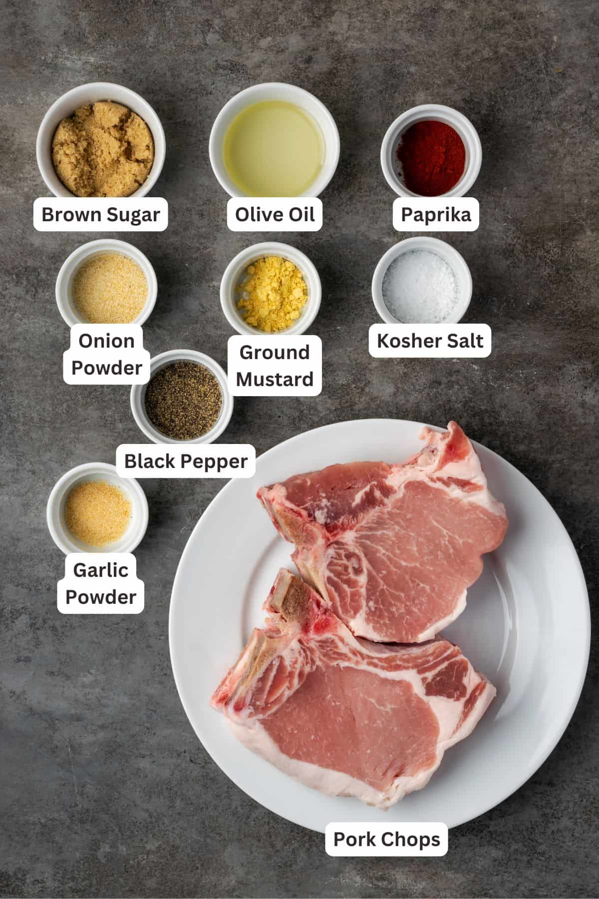 Make quick, easy, and juicy air fryer pork chops in 20 minutes! These bone-in chops are perfectly seared with a flavorful, caramelized crust. Air fryer pork chops ingredients with text labels overlaying each ingredient.