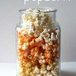 Side view of Candy Corn colored popcorn in a clear jar