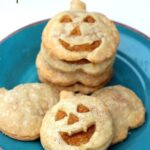 Overhead view of Pumpkin Pie Pockets with jack-o-lantern faces on a plate