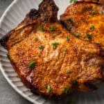 Close up of air fryer pork chops on a plate.