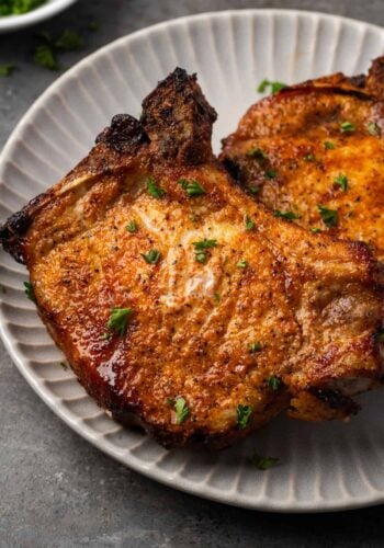 Close up of air fryer pork chops on a plate.