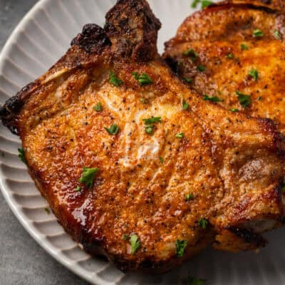 Close up of air fryer pork chops on a plate.