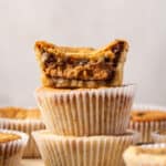 Three cookie cups stacked with a bite missing from the top cookie cup.