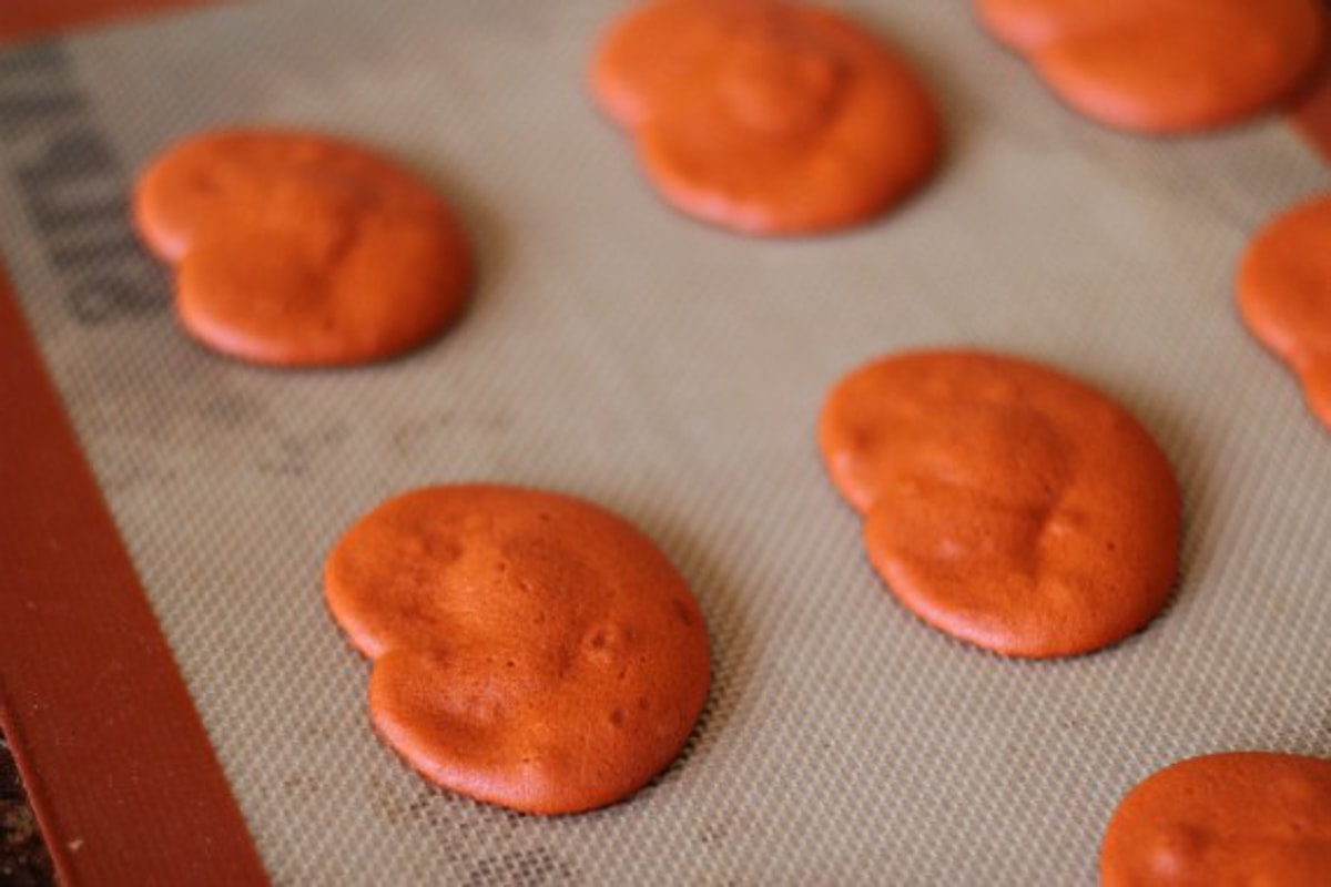 Orange pumpkin shaped cookies on a baking sheet