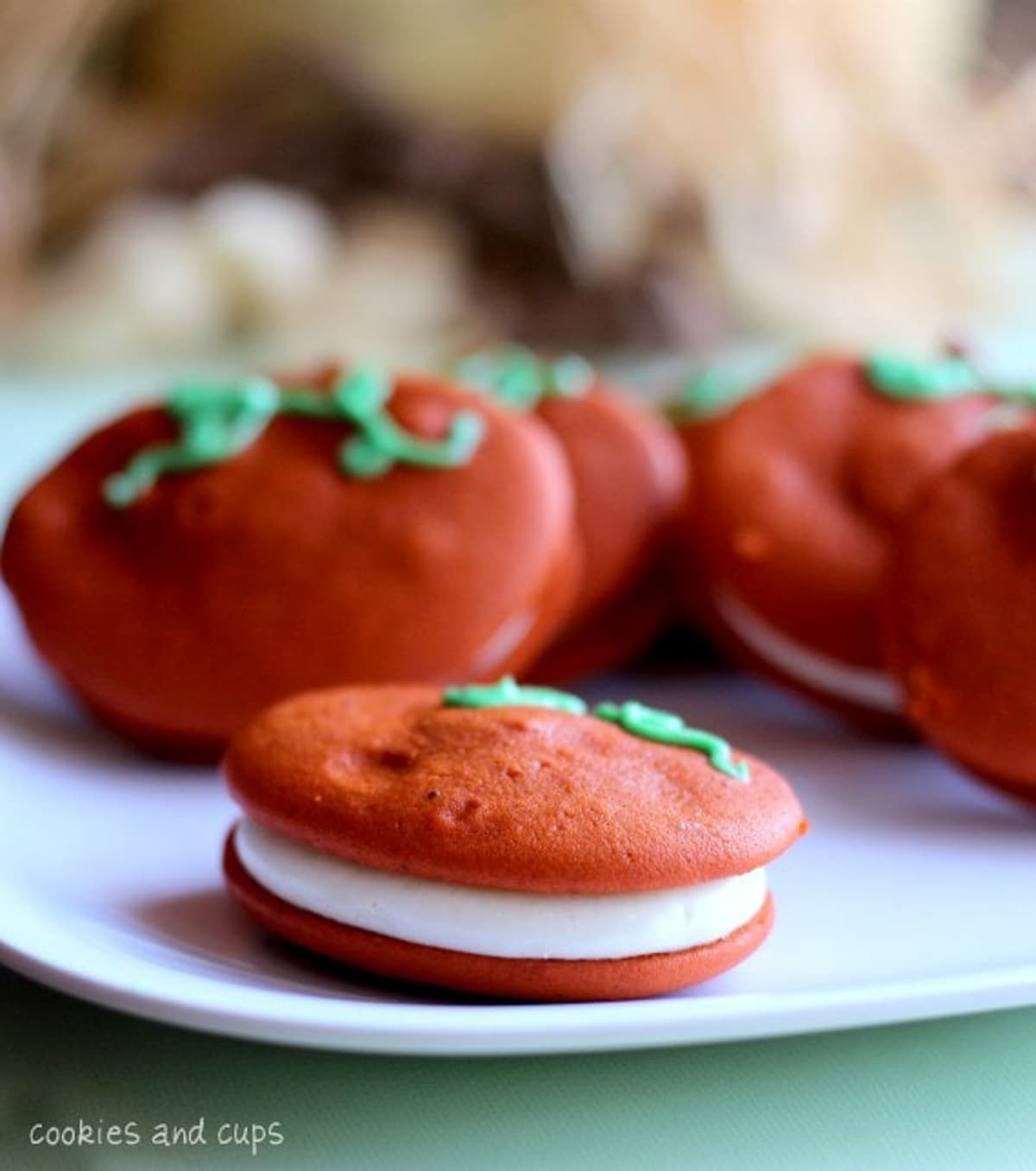 Close up of pumpkin whoopie pies on a white plate.