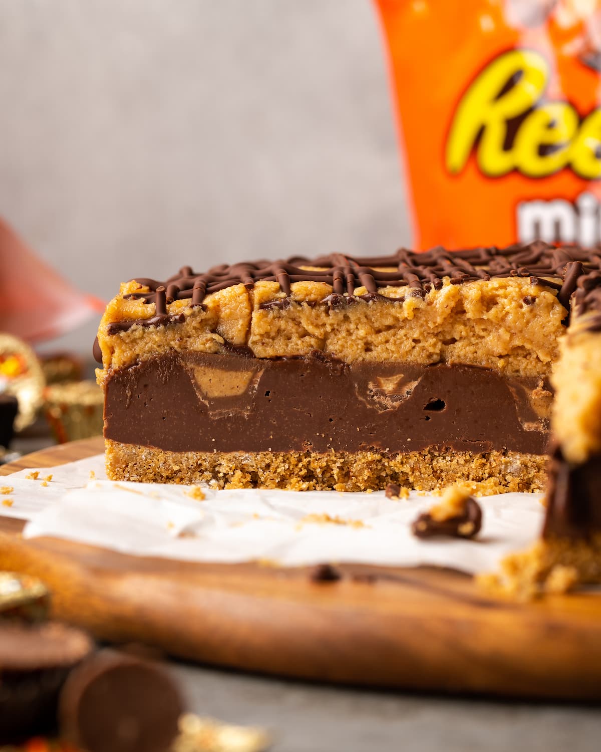 Side view of Reese's fudge pie with a slice missing to reveal the chocolate peanut butter layers.