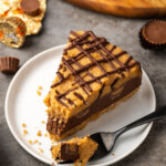 A slice of Reese's pie on a plate, next to a fork.