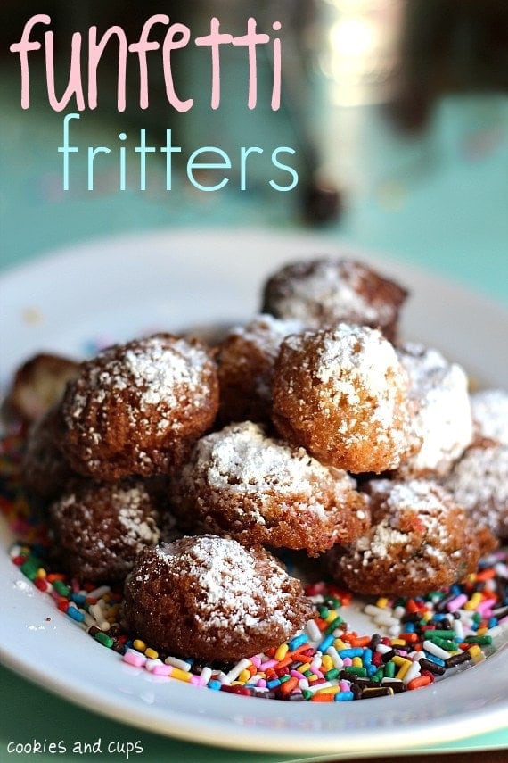 Funfetti fritters topped with powdered sugar on a plate