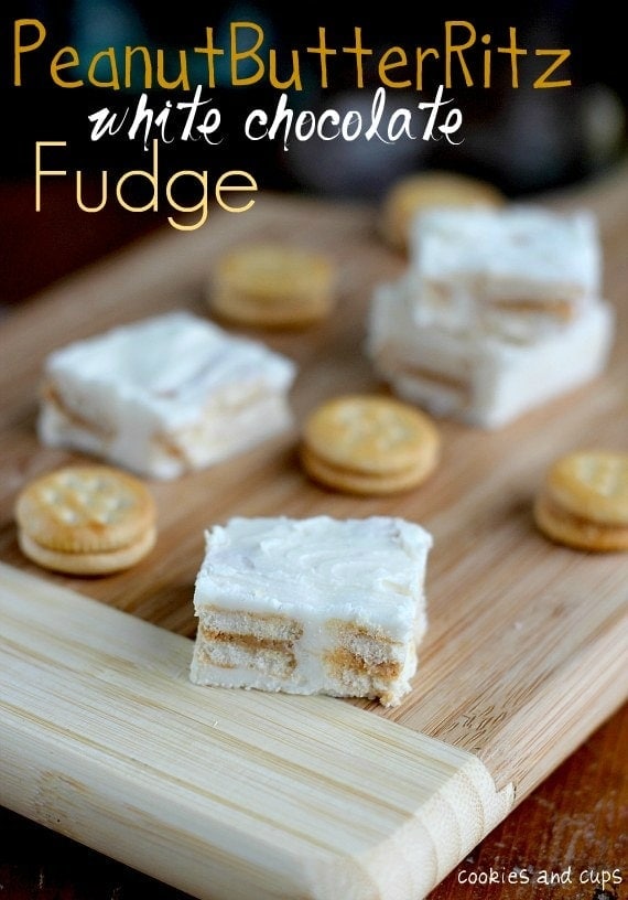 Overhead view of Peanut Butter Ritz White Chocolate Fudge and Ritz crackers on a wooden board