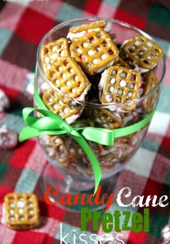 Overhead view of Candy Cane Pretzel Kisses in a clear glass with green ribbon