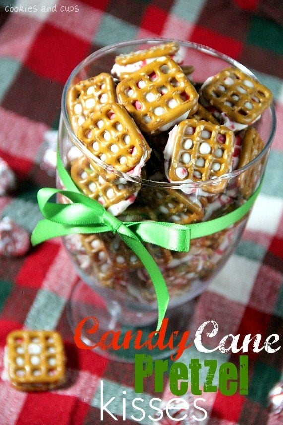 Overhead view of Candy Cane Pretzel Kisses in a clear glass with green ribbon