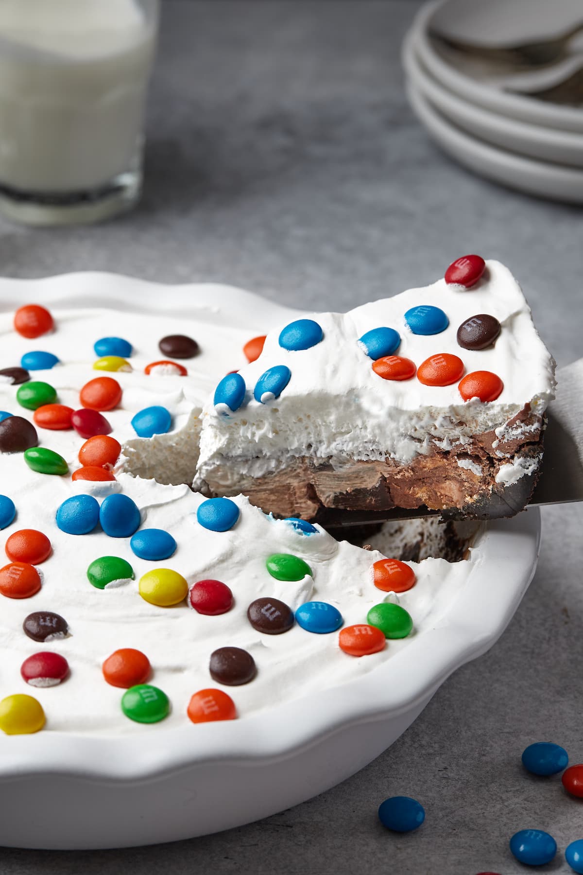 A slice of candy pie is lifted from a pie dish.
