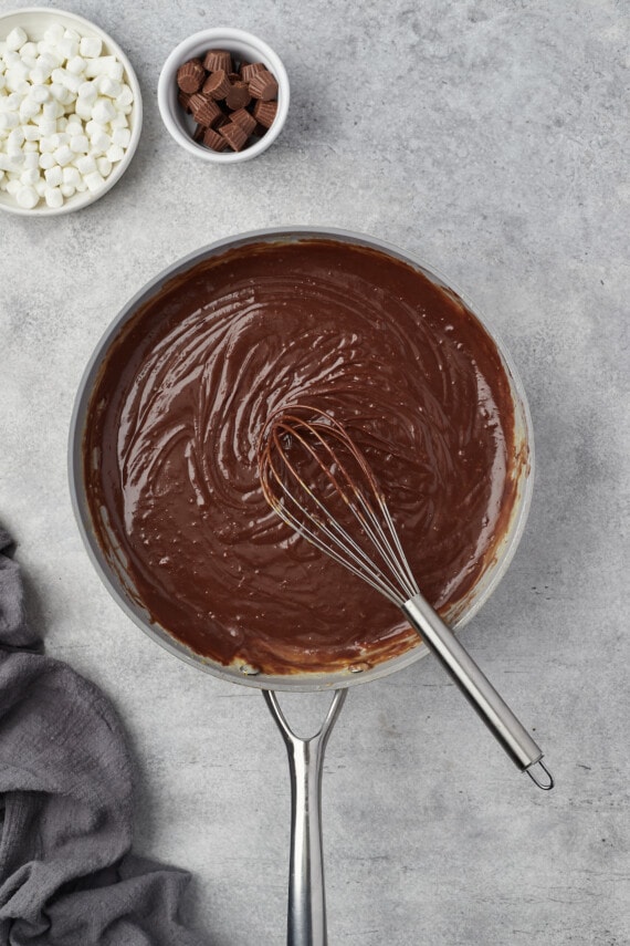Chocolate pudding is whisked in a saucepan.