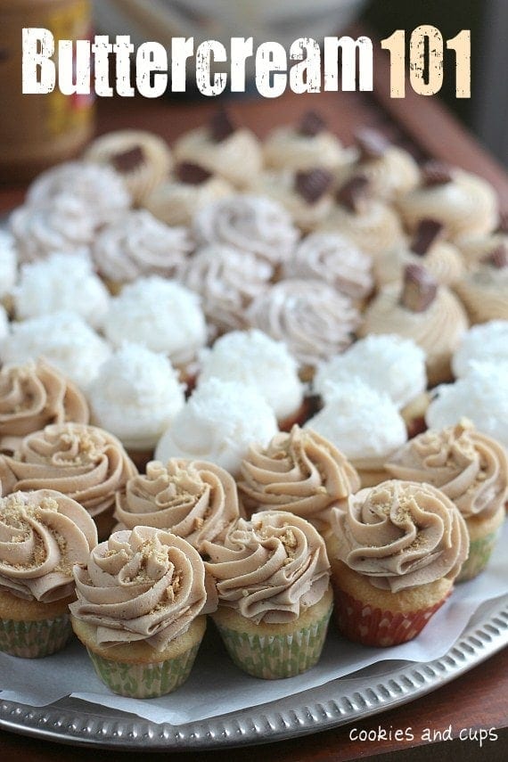 A tray of mini cupcakes with a variety of buttercream frosting swirled on top