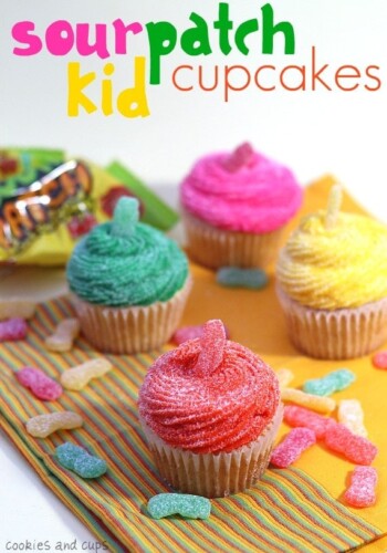Sour Patch Kid Cupcakes on a napkin with Sour Patch Kid candies sprinkled around