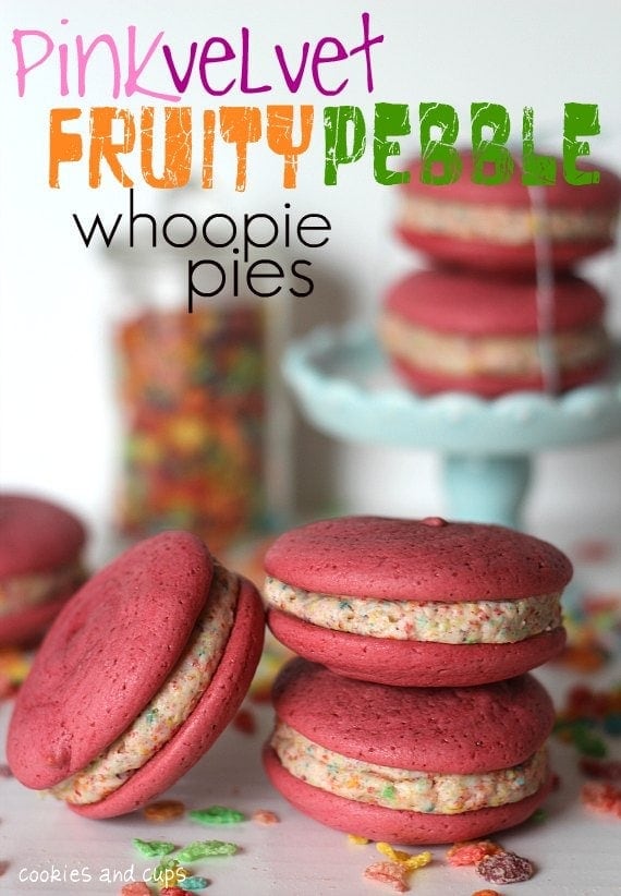 Pink Velvet Fruity Pebble whoopie pies stacked in front of a cake stand