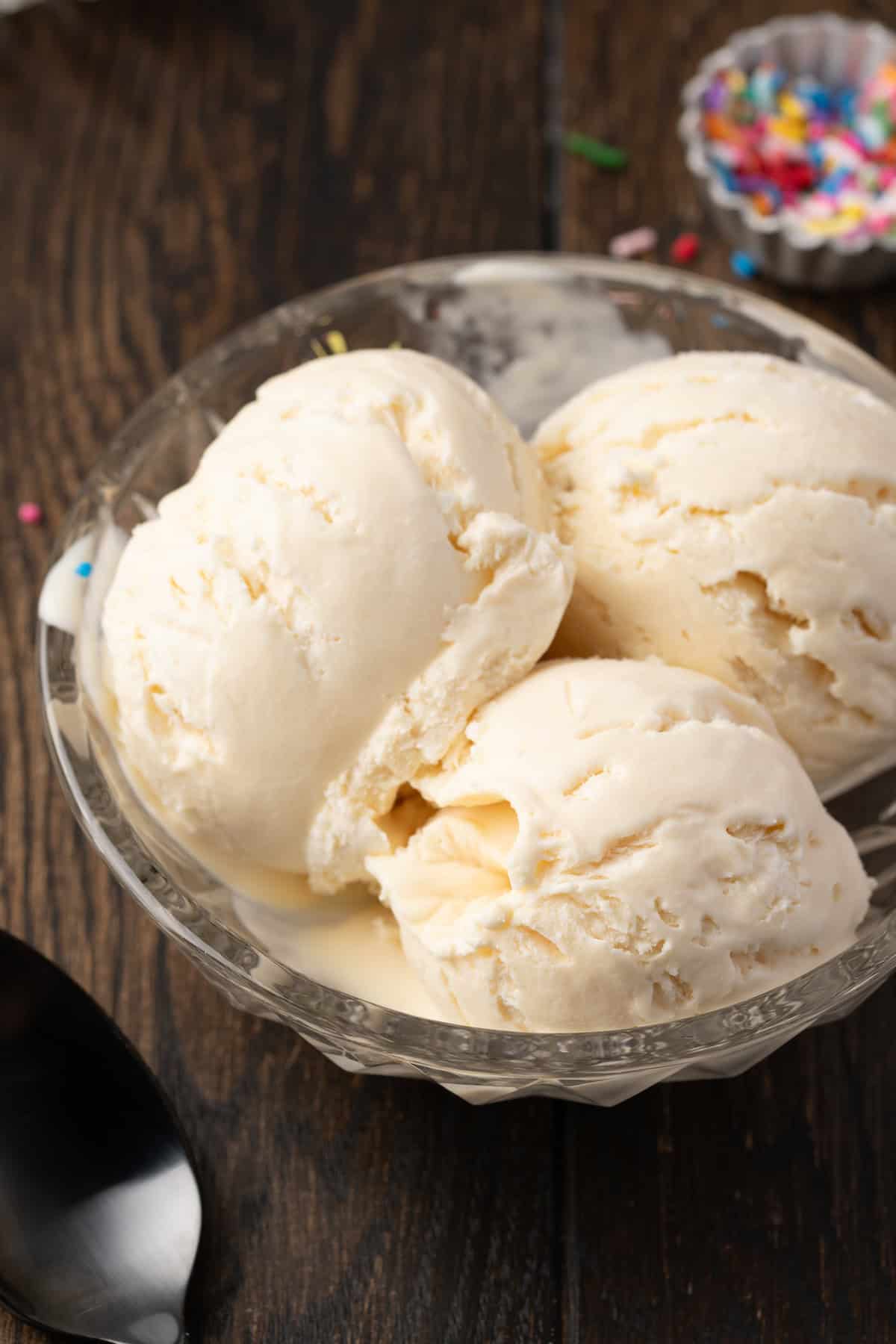 Three scoops of vanilla ice cream in a bowl.
