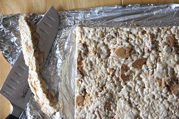 The edges are trimmed from a slab of Nutter Butter peanut butter rice krispie treats.