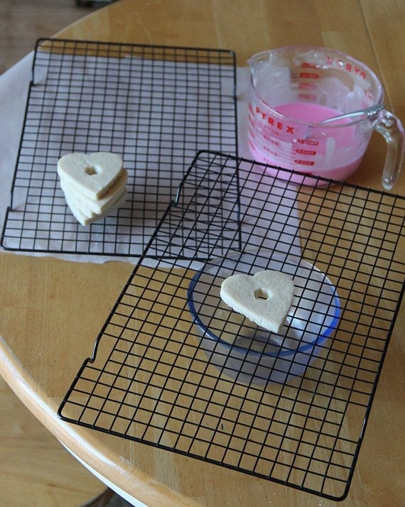 Heart-shaped cookies on wire racks.