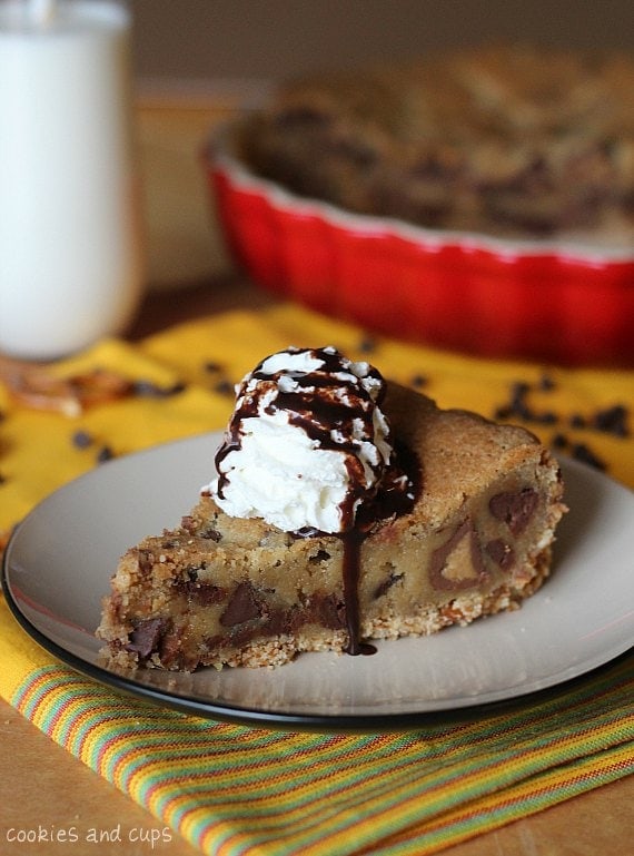 A slice of Pretzel Crusted Peanut Butter Cup Blondie Pie with ice cream on top