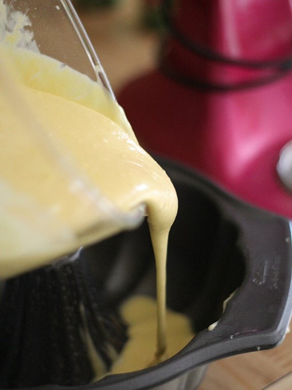 Cake batter is poured into a bundt pan.