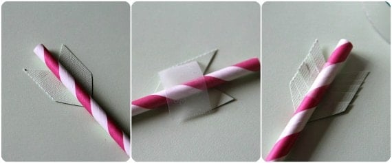 Cupid's arrows are assembled from straws and cutout paper.