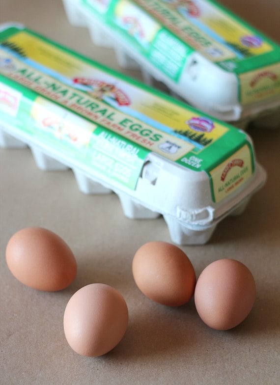 Brown eggs in front of two packages of Land O Lakes eggs