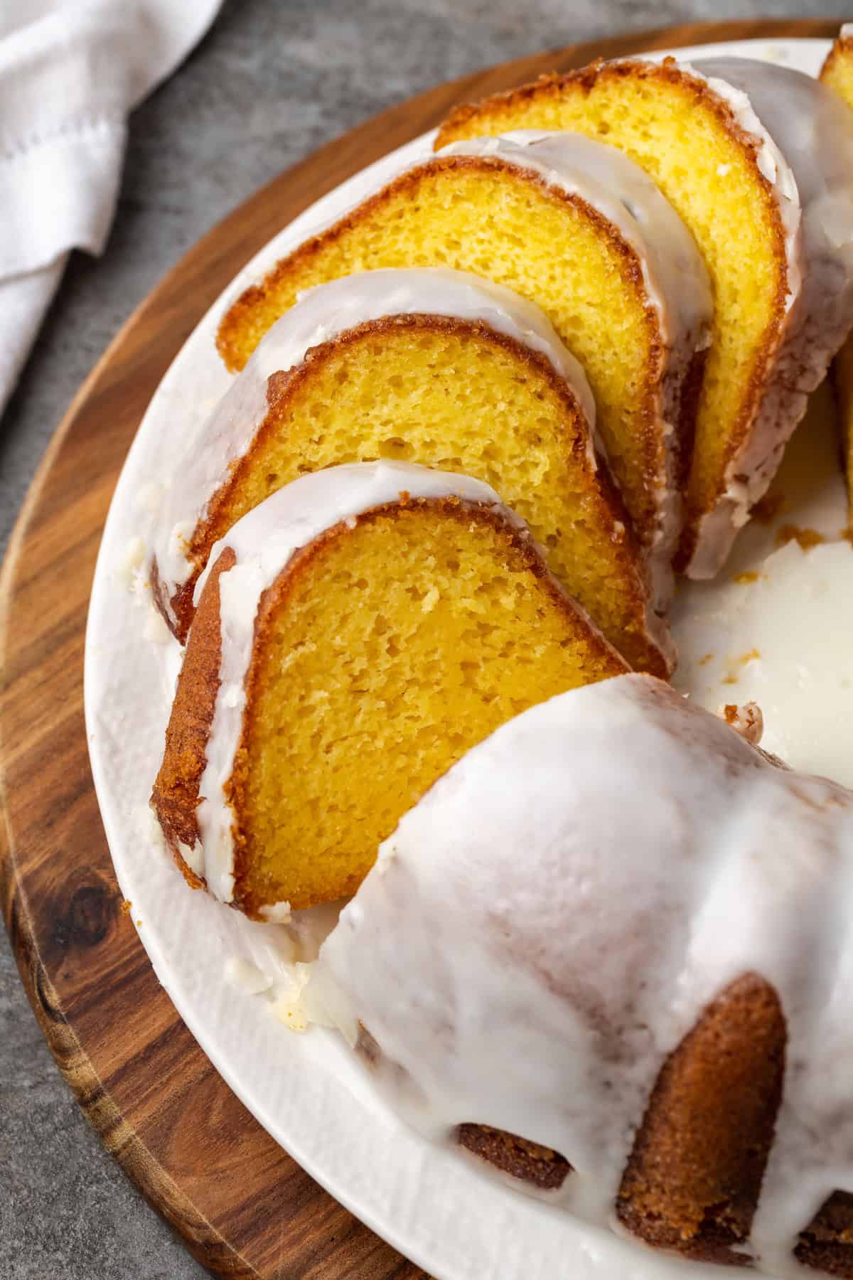 Slice the glazed Mountain Dew Bundt cake on a plate.