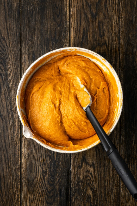 Cake mix pumpkin cookie dough combined in a mixing bowl with a spatula.