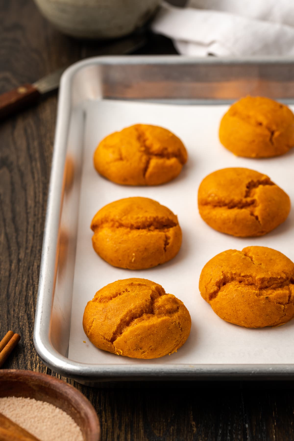 Baked cake mix pumpkin cookies on a metal baking sheet.