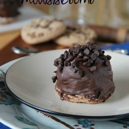 Plate with a chocolate chip cookie mousse bomb on it