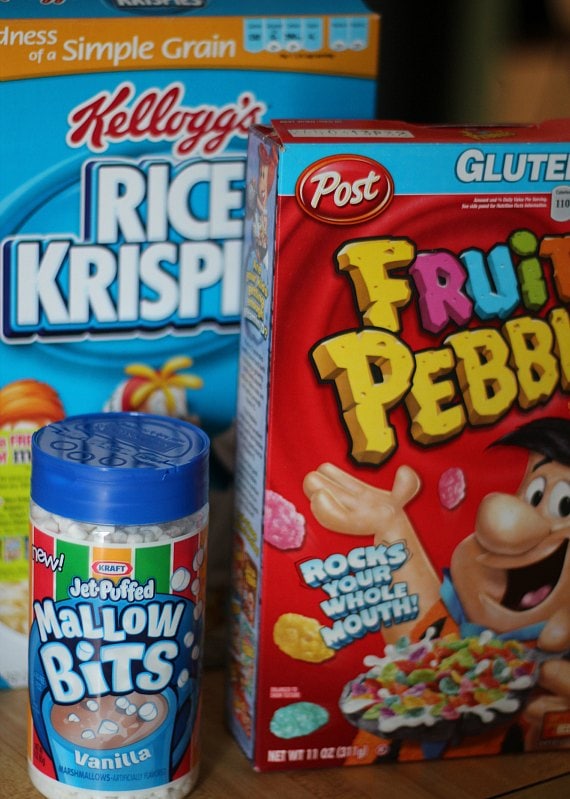 Boxes of Rice Krispie and Fruity Pebbles cereals and a jar of Marshmallow Bits.