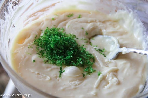 Lime zest is added into a bowl of fudge ingredients.