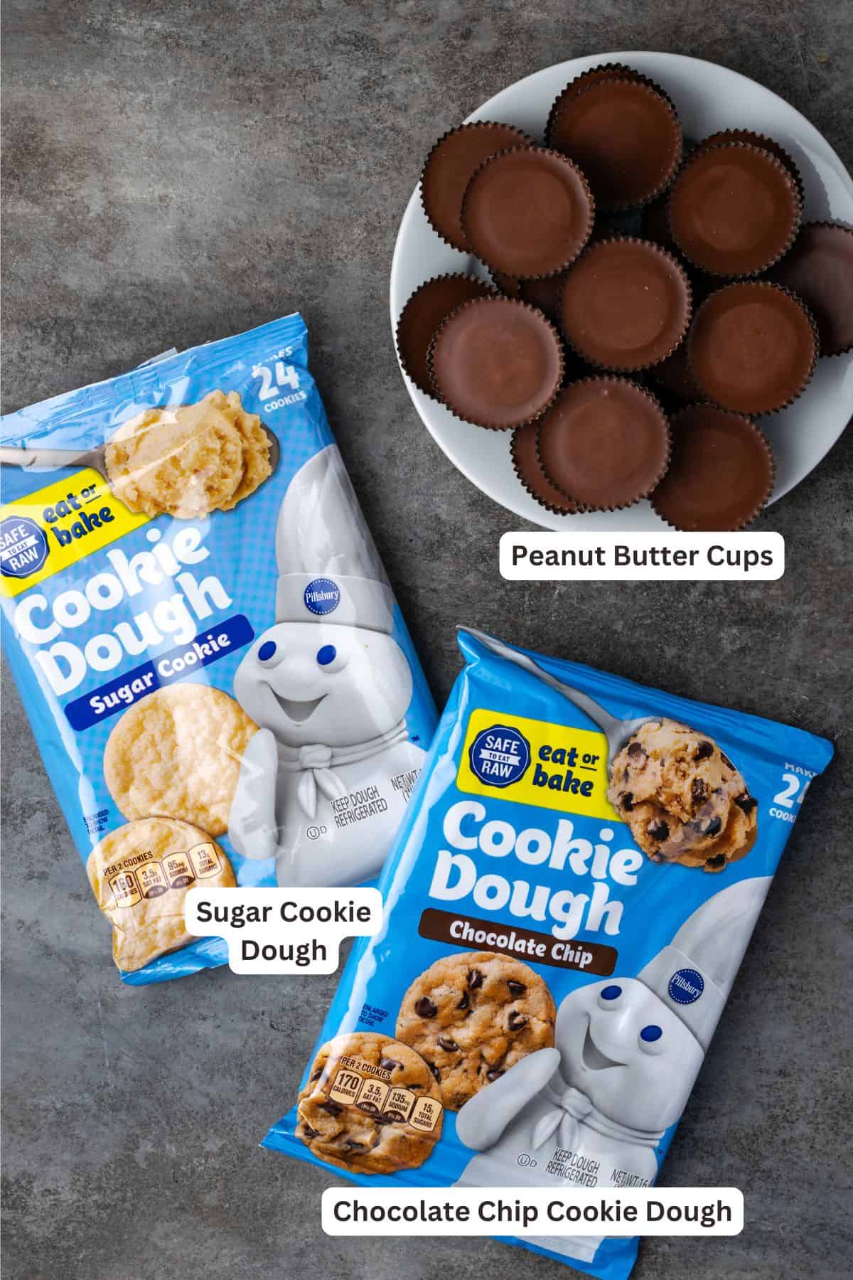 These are the ultimate cookie cups with two types of refrigerated cookie dough baked around a fudgy peanut butter cup. Quick and easy to make! Cookie cups ingredients including refrigerated chocolate chip cookie dough, sugar cookie dough, and Reese's peanut butter cups.
