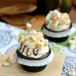 A s'mores cupcake with toasted marshmallows on top